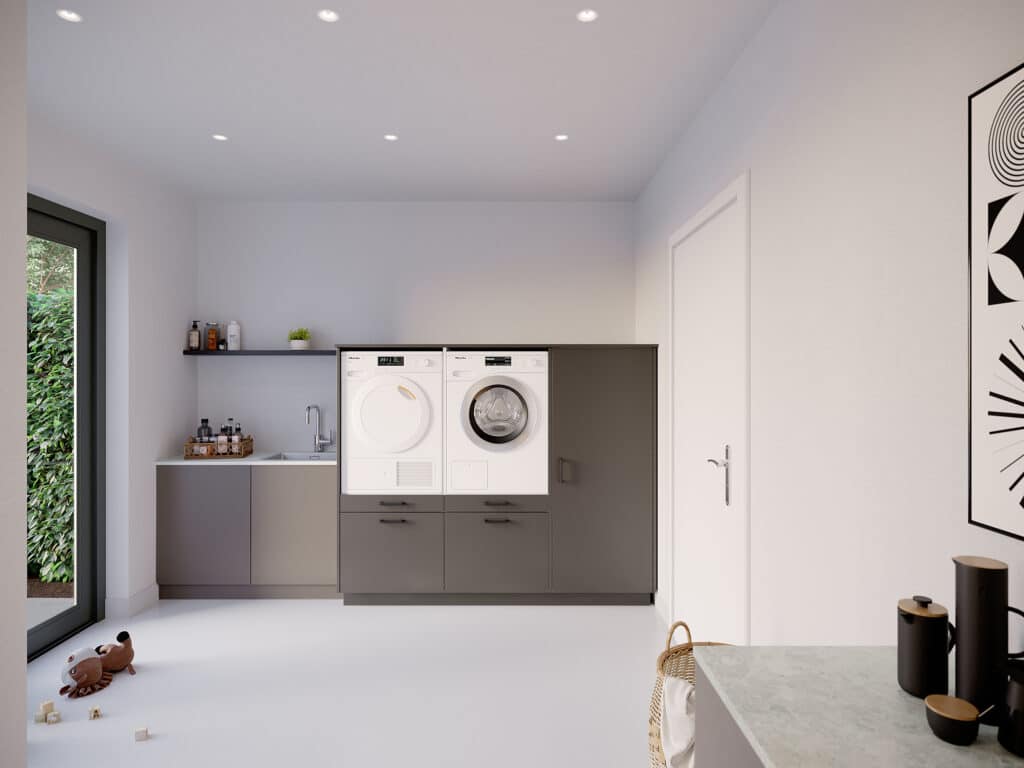 Moderne 'Three of a kind' wasmachinekast in 'metallic black' met 'ara zwart matte' handgrepen, voor een wasmachine en droger in een nette wasruimte.